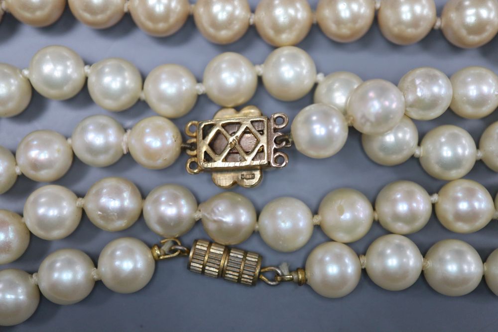 A single strand cultured pearl necklace and two simulated pearl necklaces.